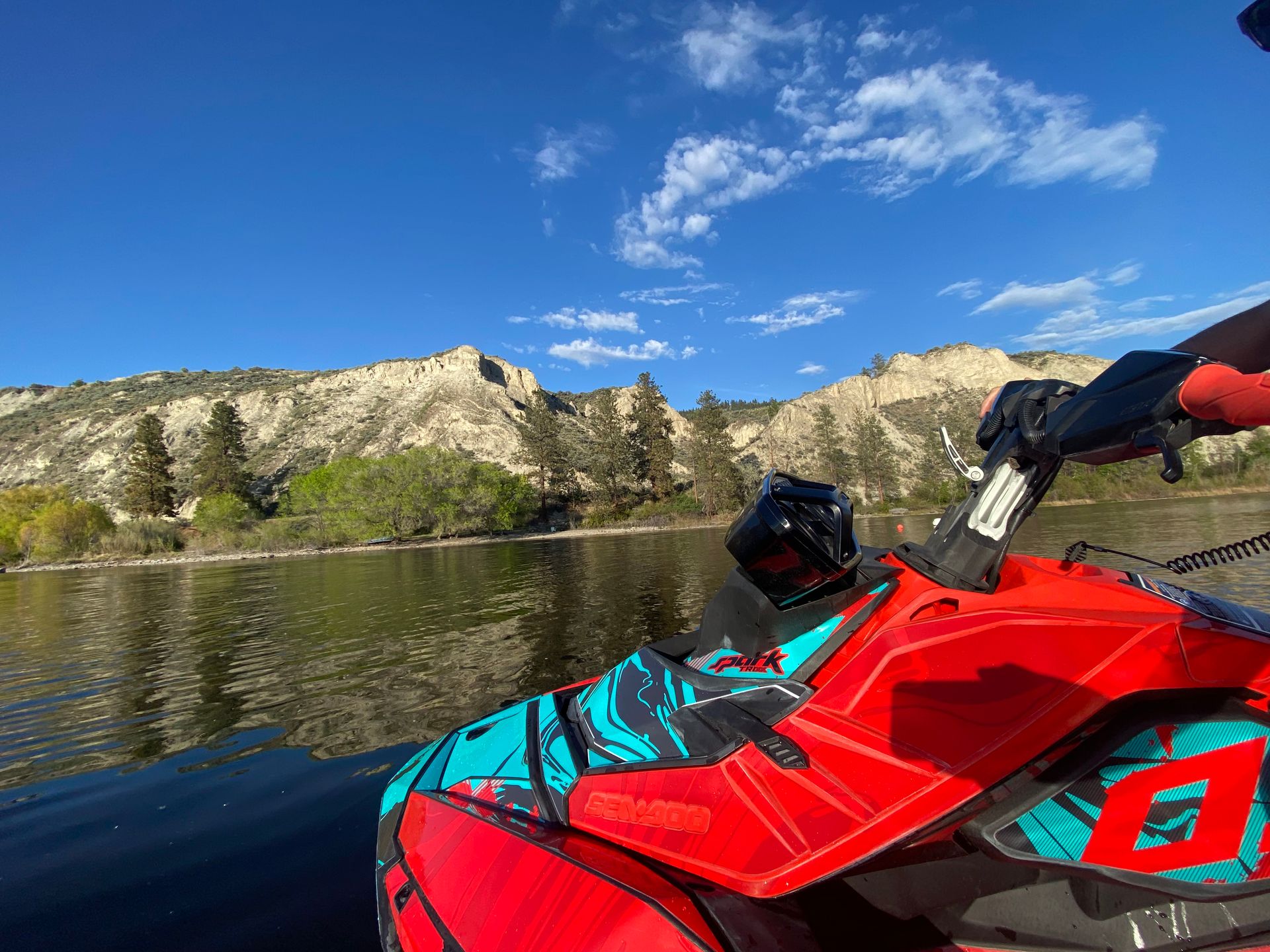 The view over a Sea-Doo’s handlebars toward white clay cliffs
